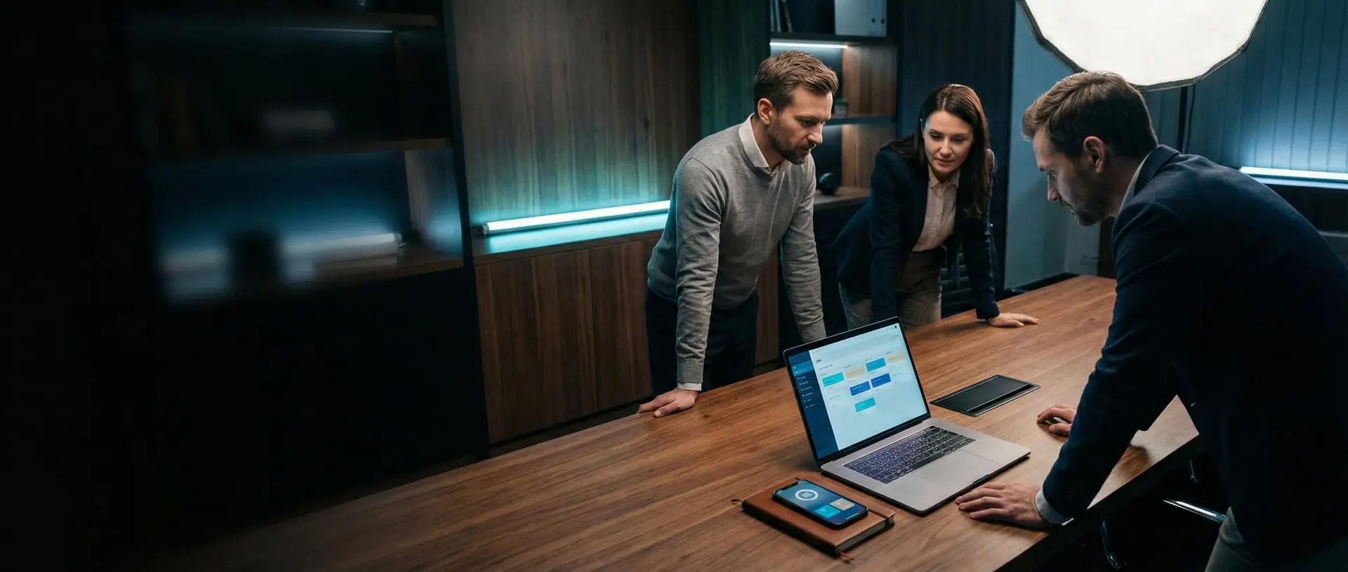 Operators reviewing lead-path notes, analytics, and next steps together at a strategy desk